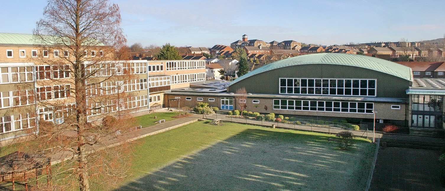 Photo of The Halley Academy building taken from a green space on the academy grounds.