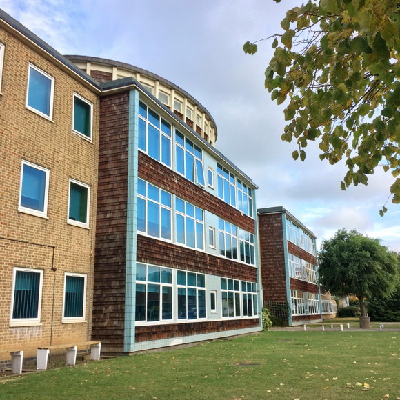 Photo of The Halley Academy building taken from a green space on the academy grounds.