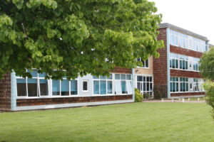 Photo of The Halley Academy building taken from a green space on the academy grounds.