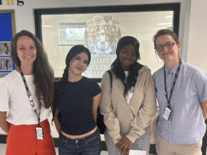 two students and two teachers smiling at camera